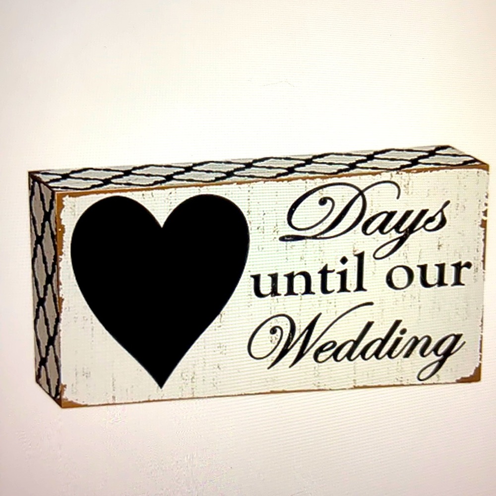 “Days until our wedding” chalkboard block sign.